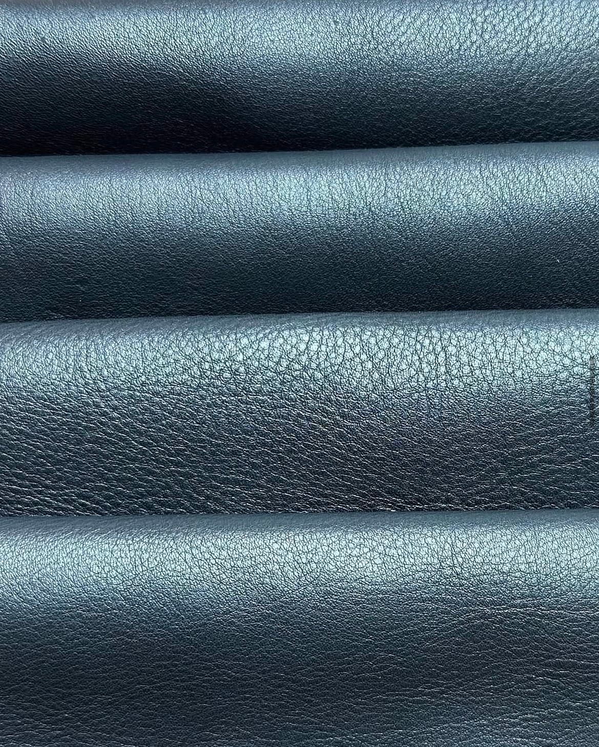 Blue-black leather held close for inspection.