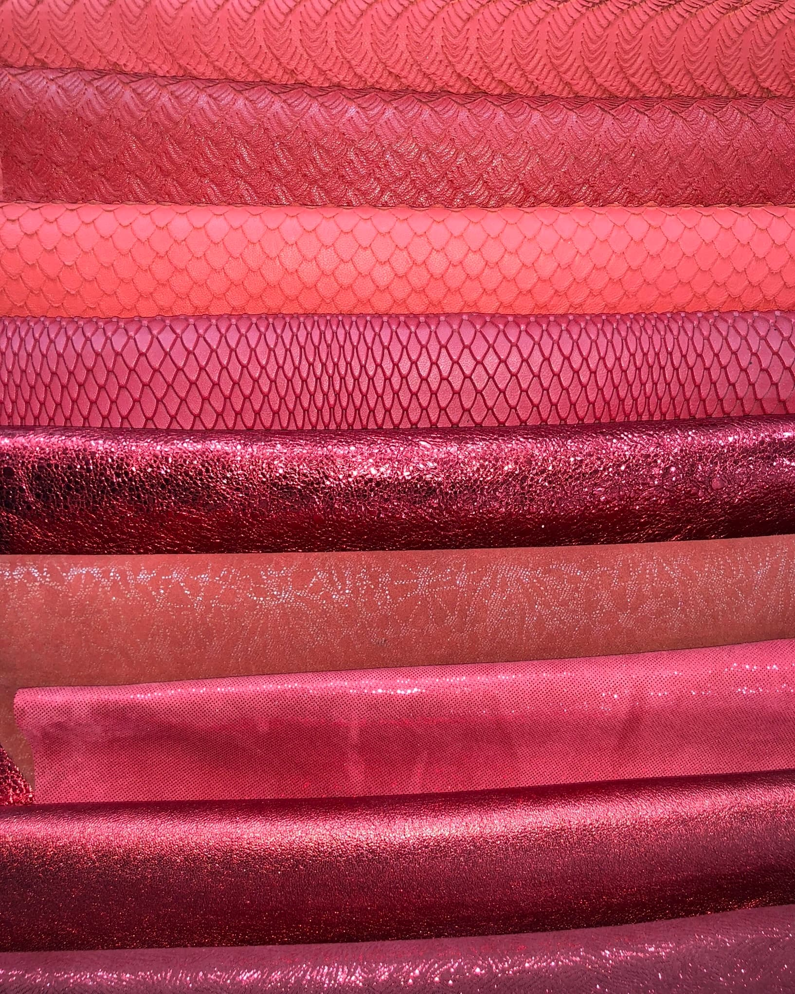 Leather articles arranged across a cutting table.